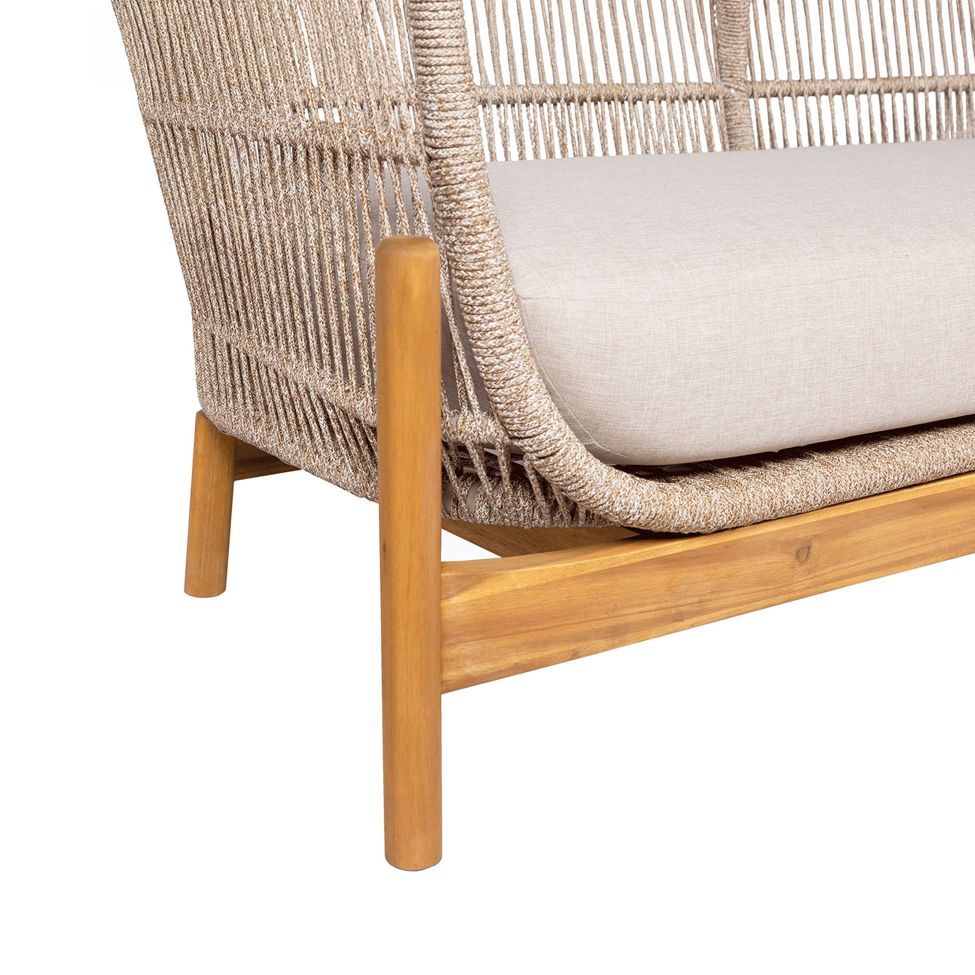Wicker chair with wooden legs and white cushion on a white background