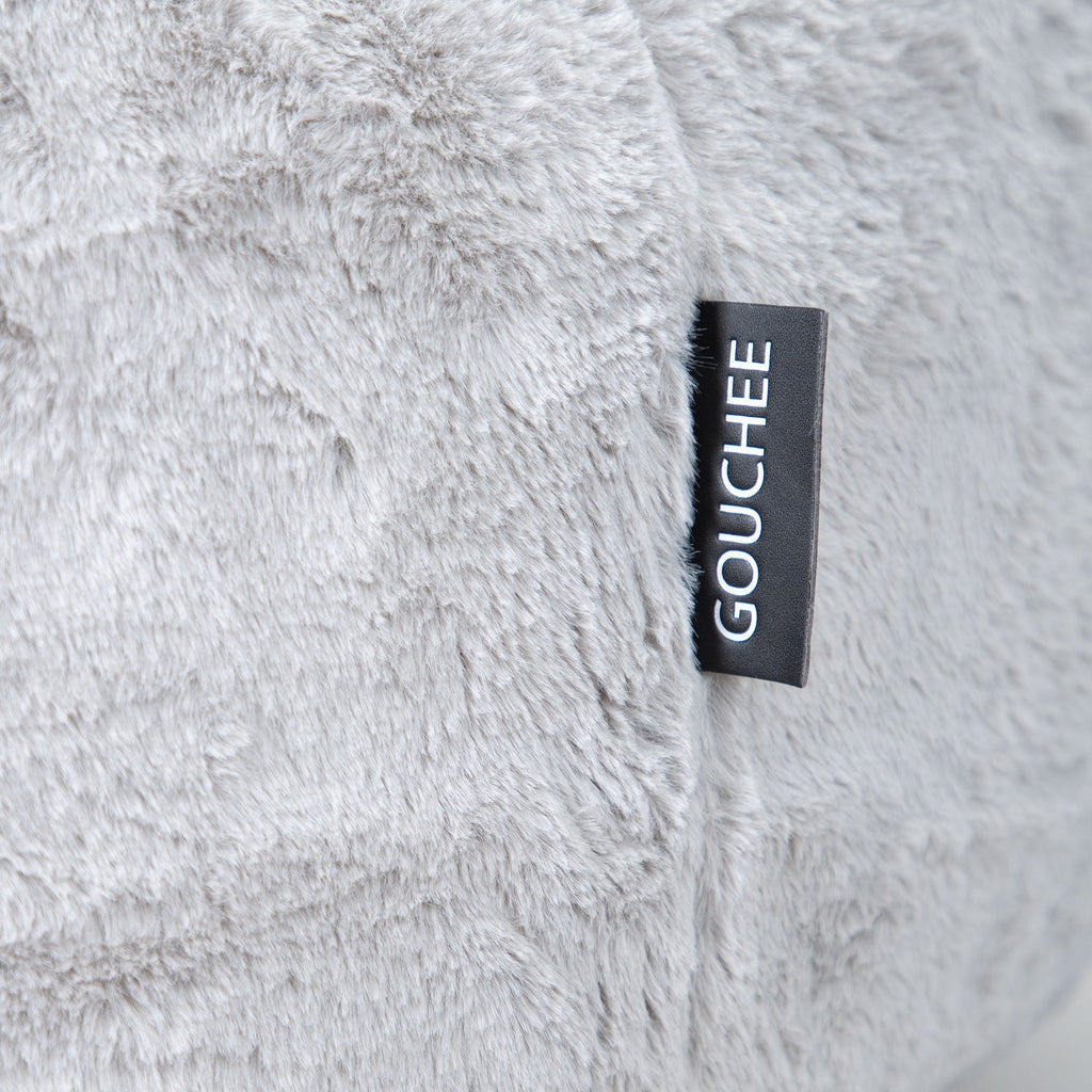 Close-up of a fluffy gray fabric with a 'Gouchee' label.