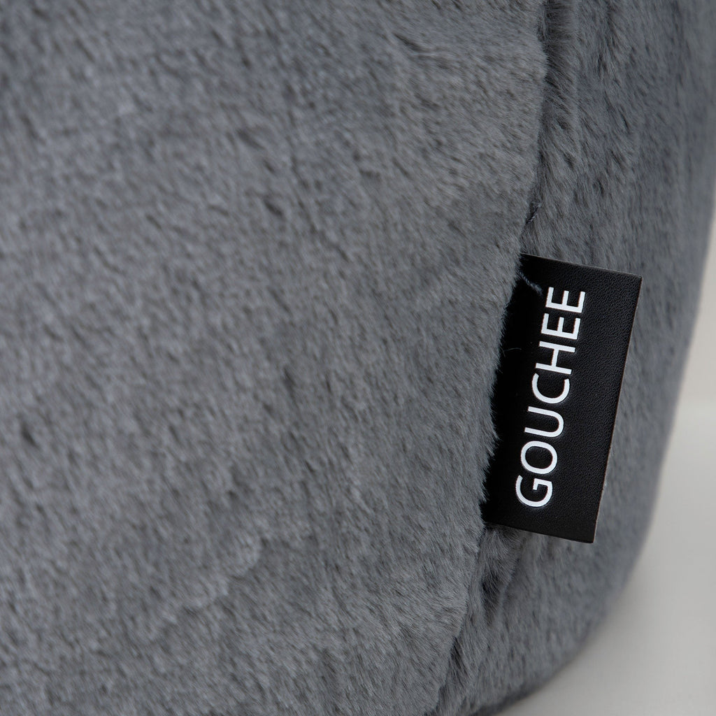 Gray textured pillow with a Gouché label