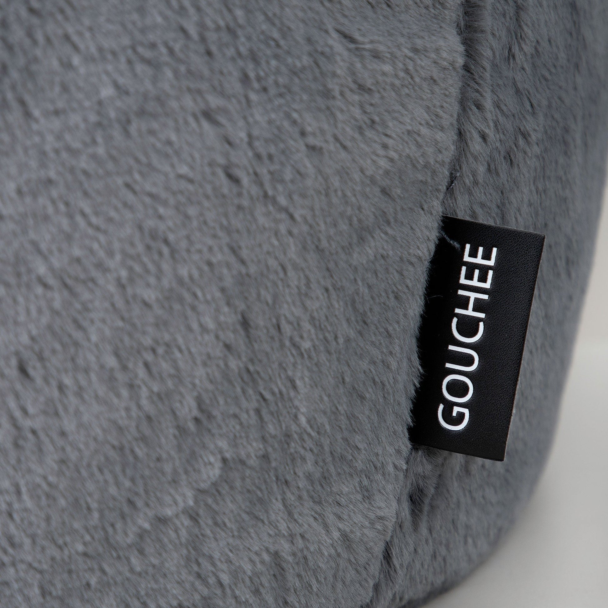 Gray textured pillow with a Gouché label