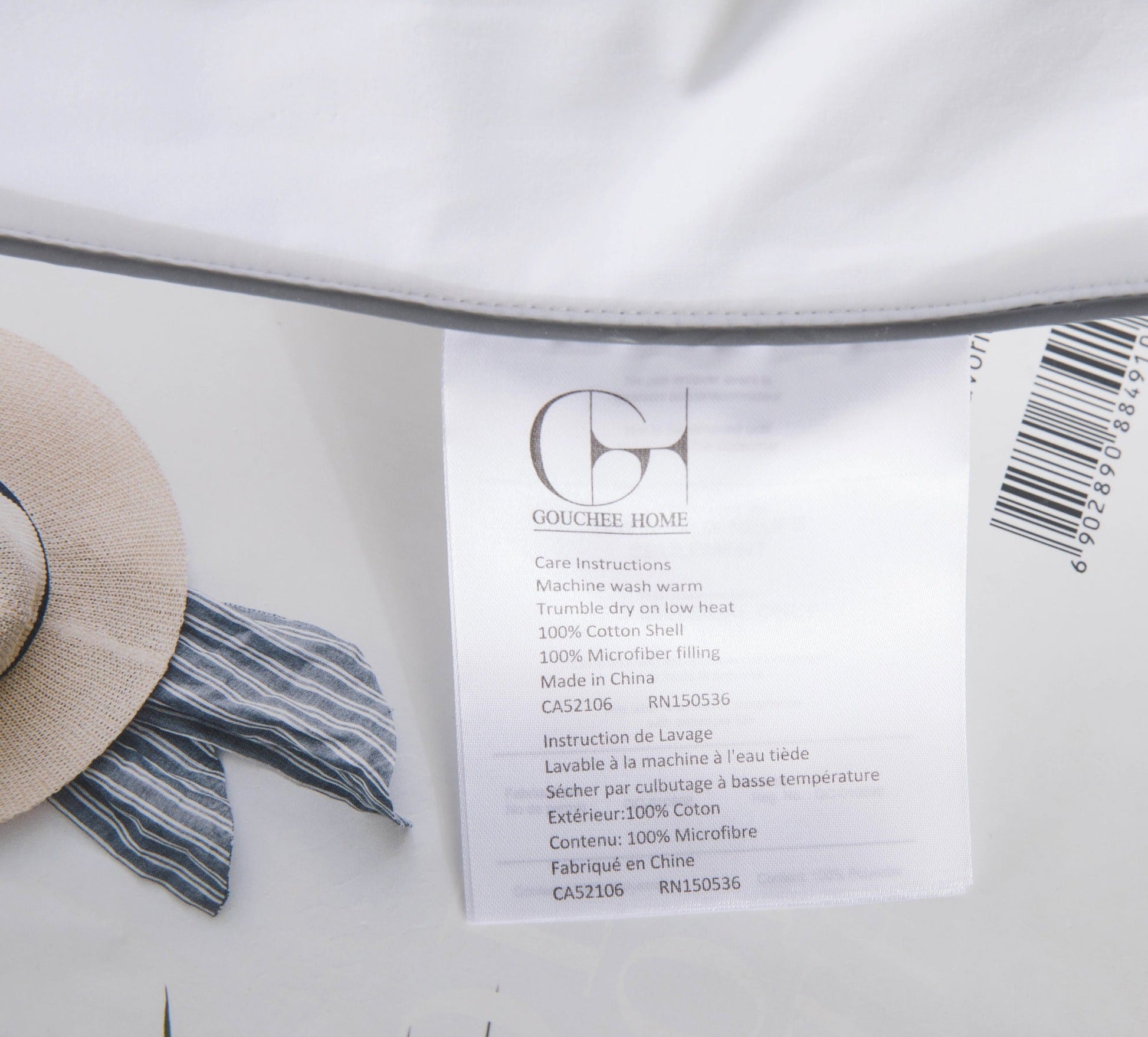 Close-up of a label on a garment with a hat and scarf in the background