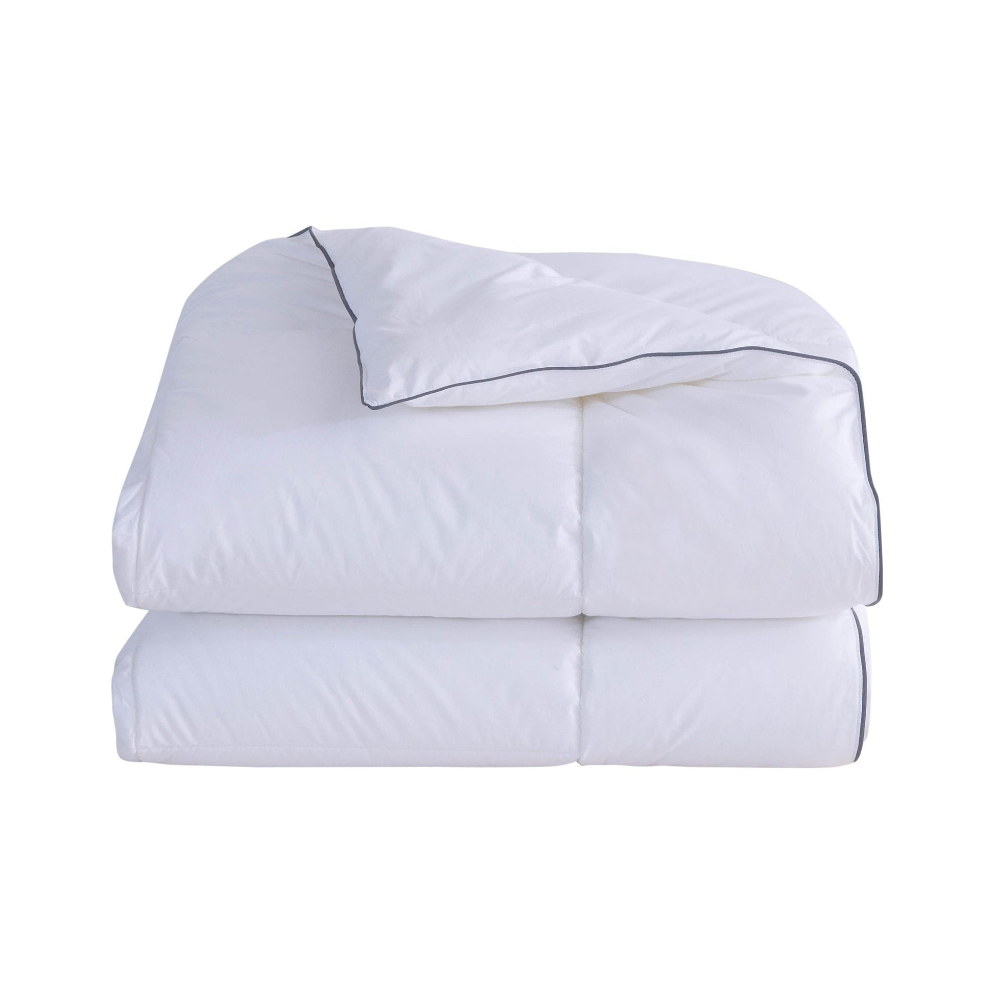 Folded white comforter with black piping on a white background