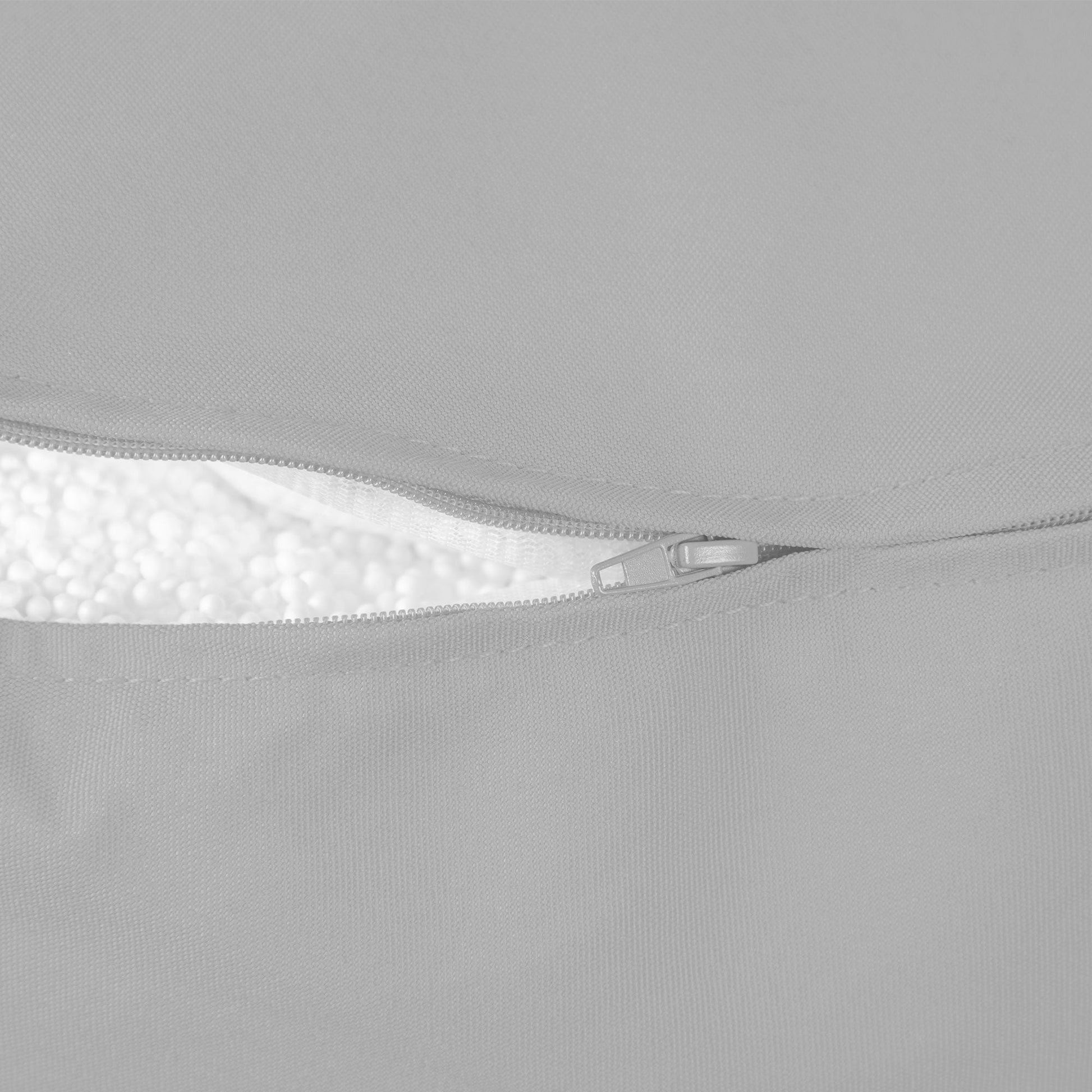 Close-up of a gray fabric with a zipper detail on a light gray background