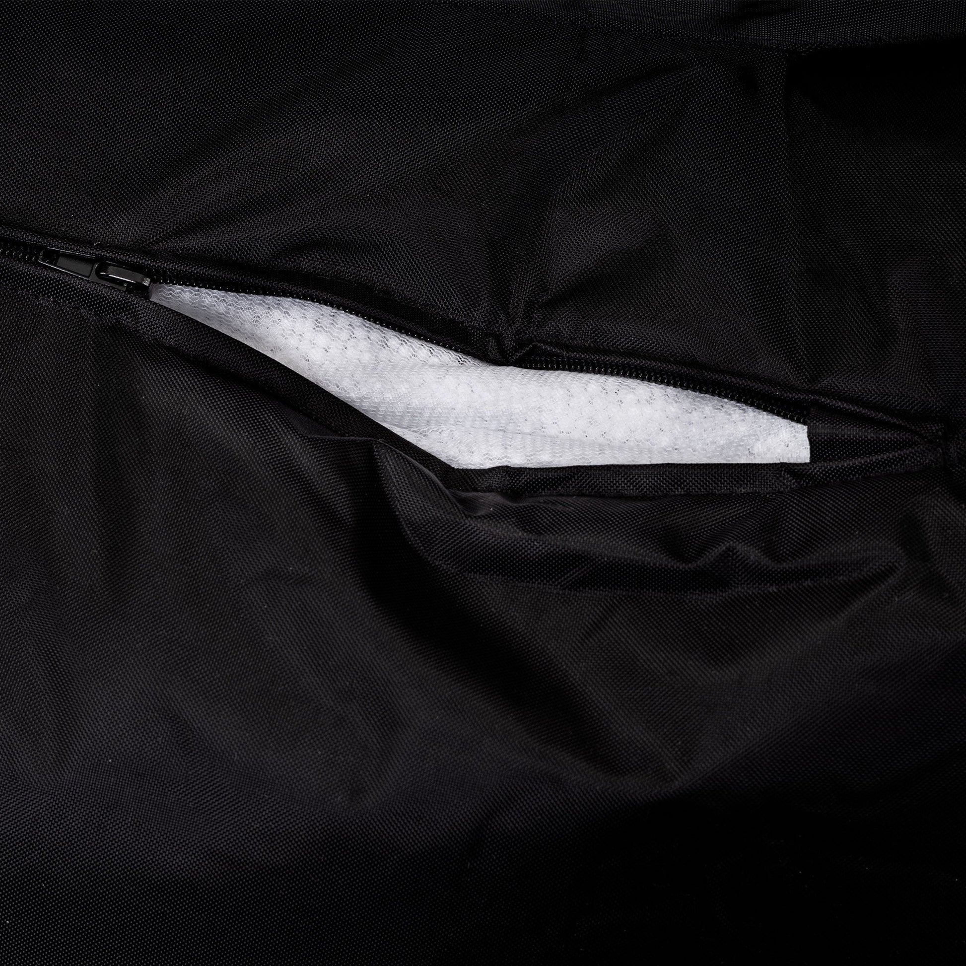 Close-up of a black bag interior with white foam padding