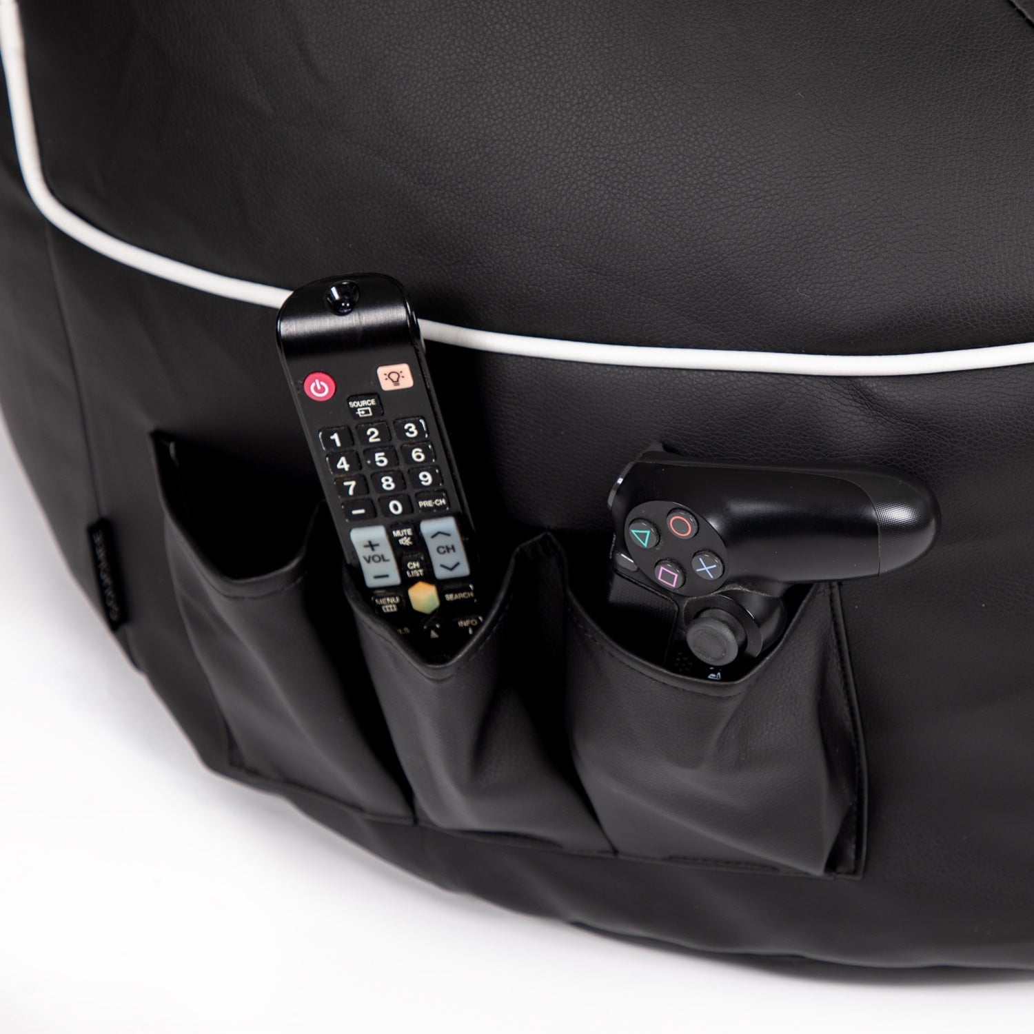 Black bag with remote controls and a handheld device on a white background