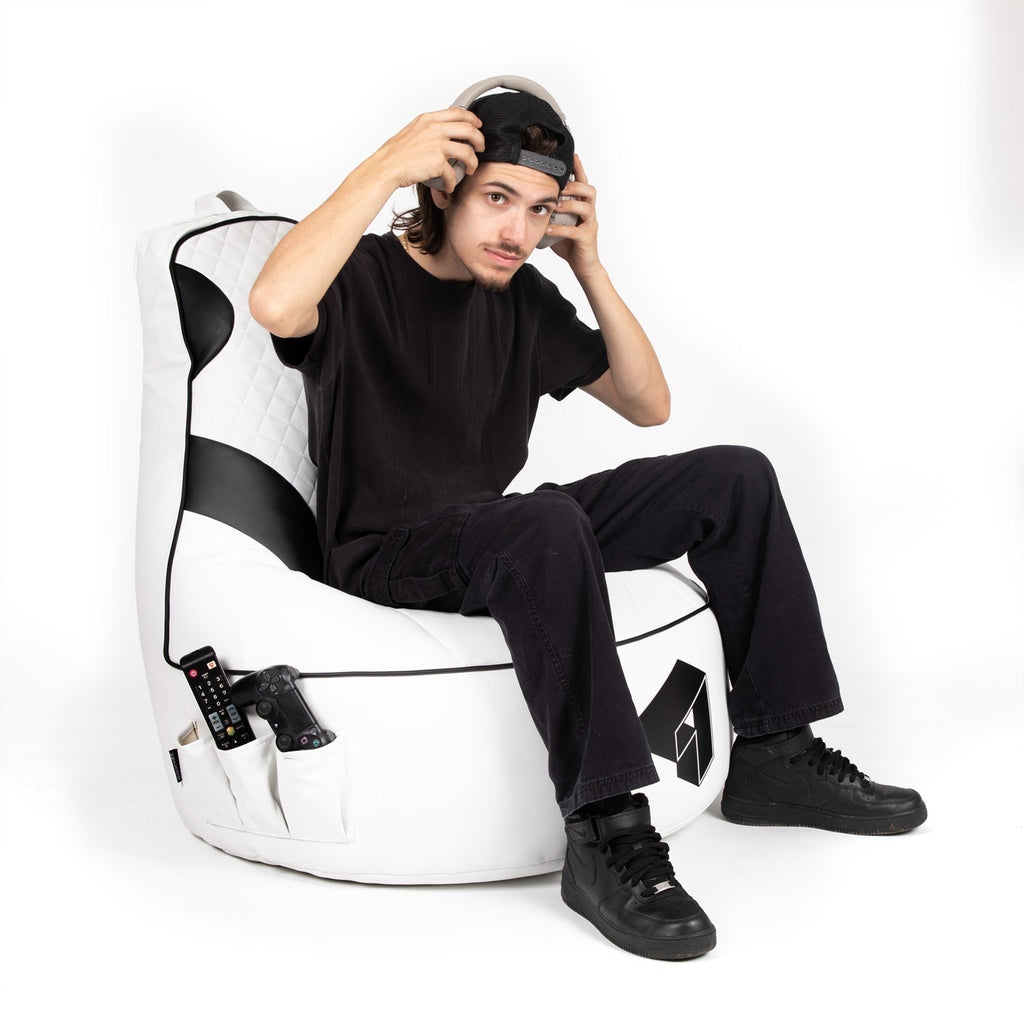 Person sitting on a white bean bag chair with black patterns against a white background