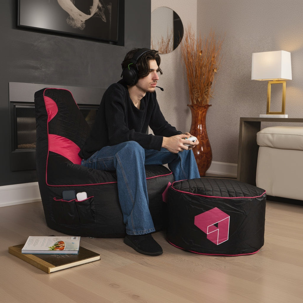 Person sitting on a black and pink bean bag chair in a living room setting.
