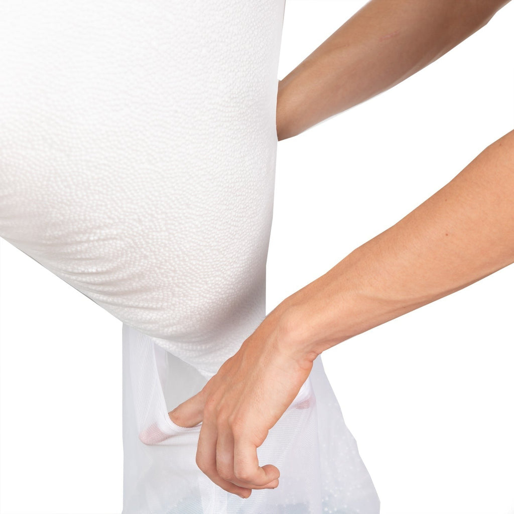 Person holding a white pillowcase with a plain background
