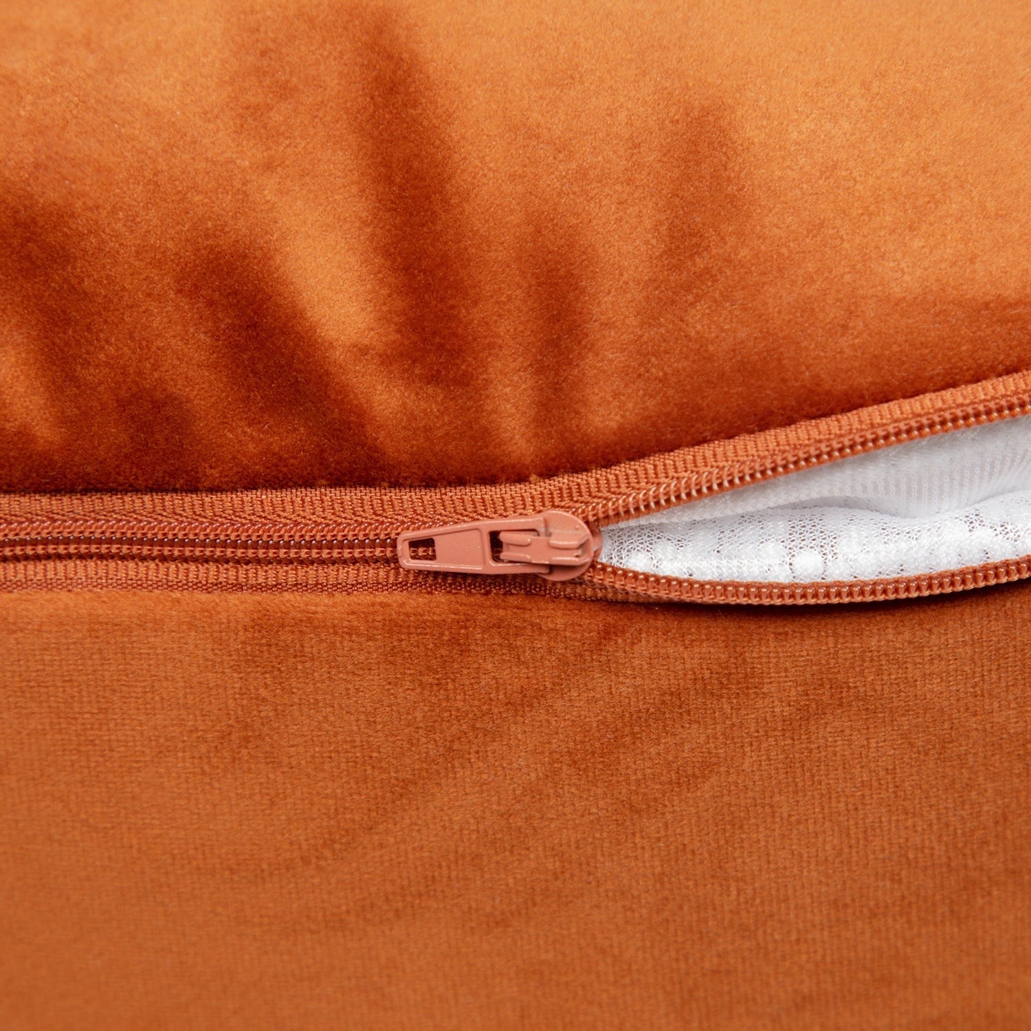 Close-up of a brown zipper on a textured surface