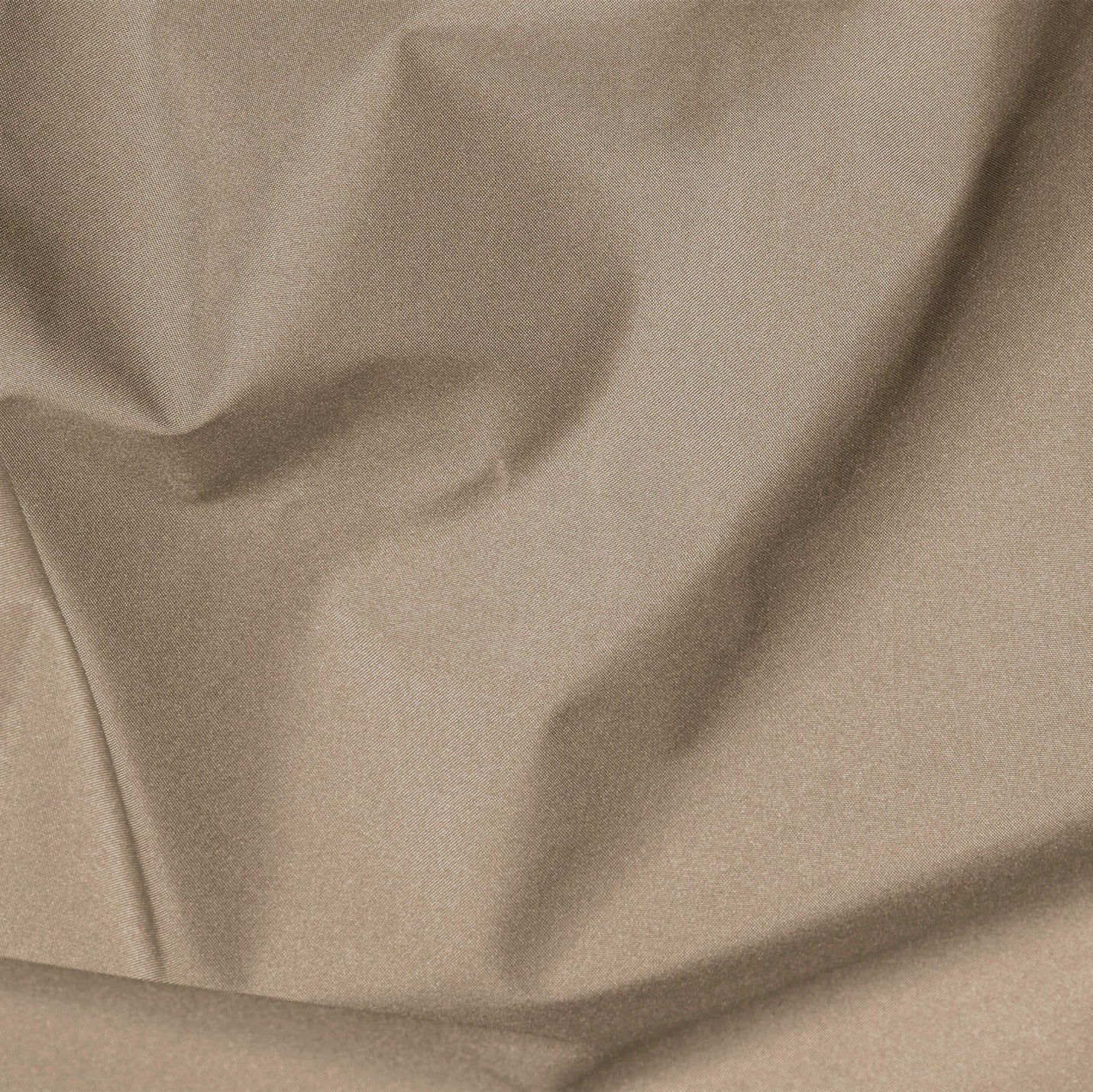 Close-up of beige fabric with folds