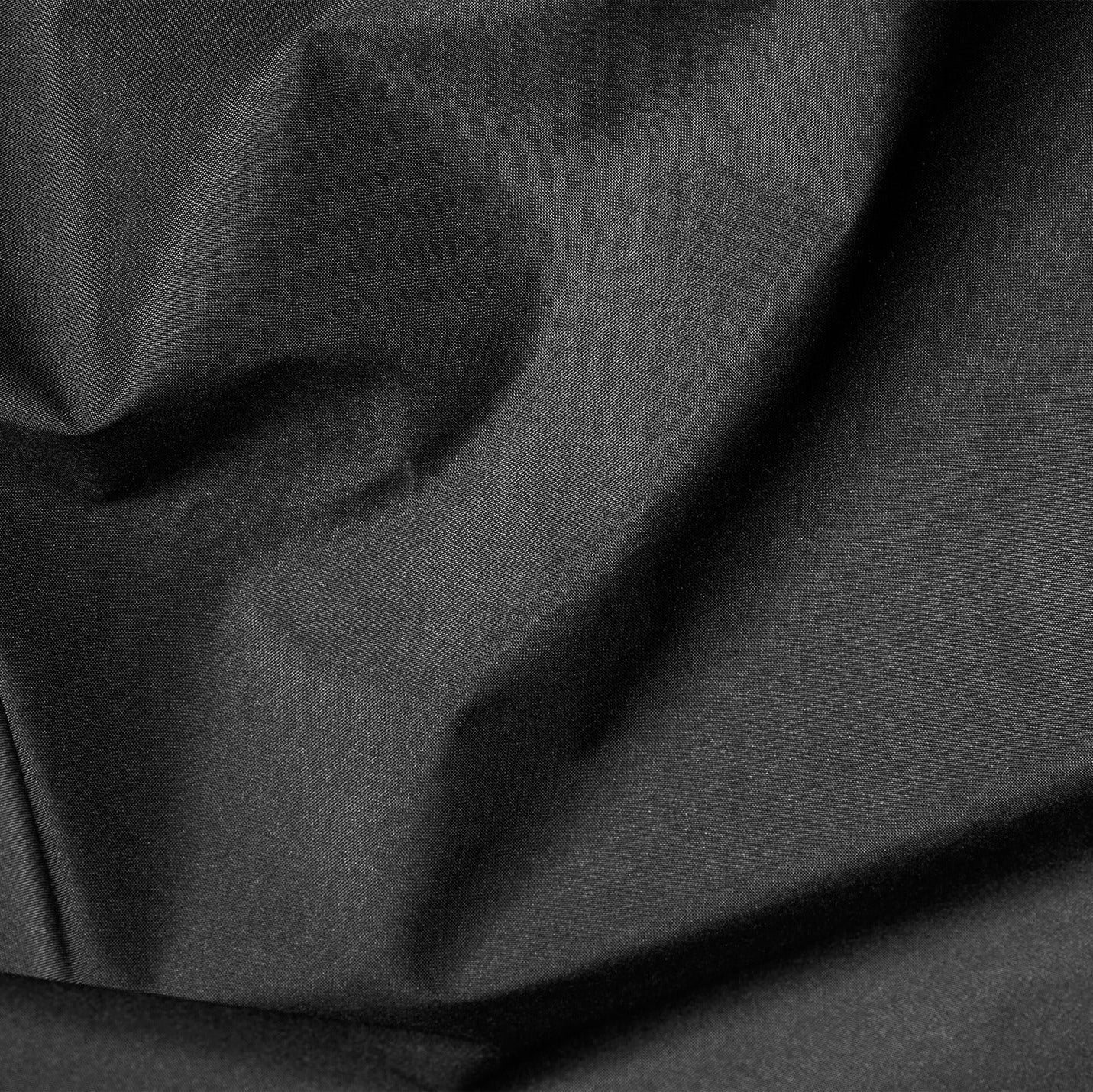 Close-up of dark gray fabric with folds