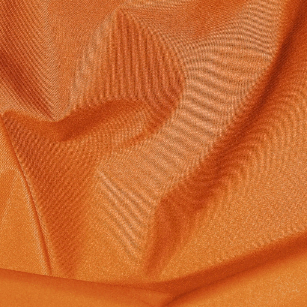Close-up of orange fabric with visible texture