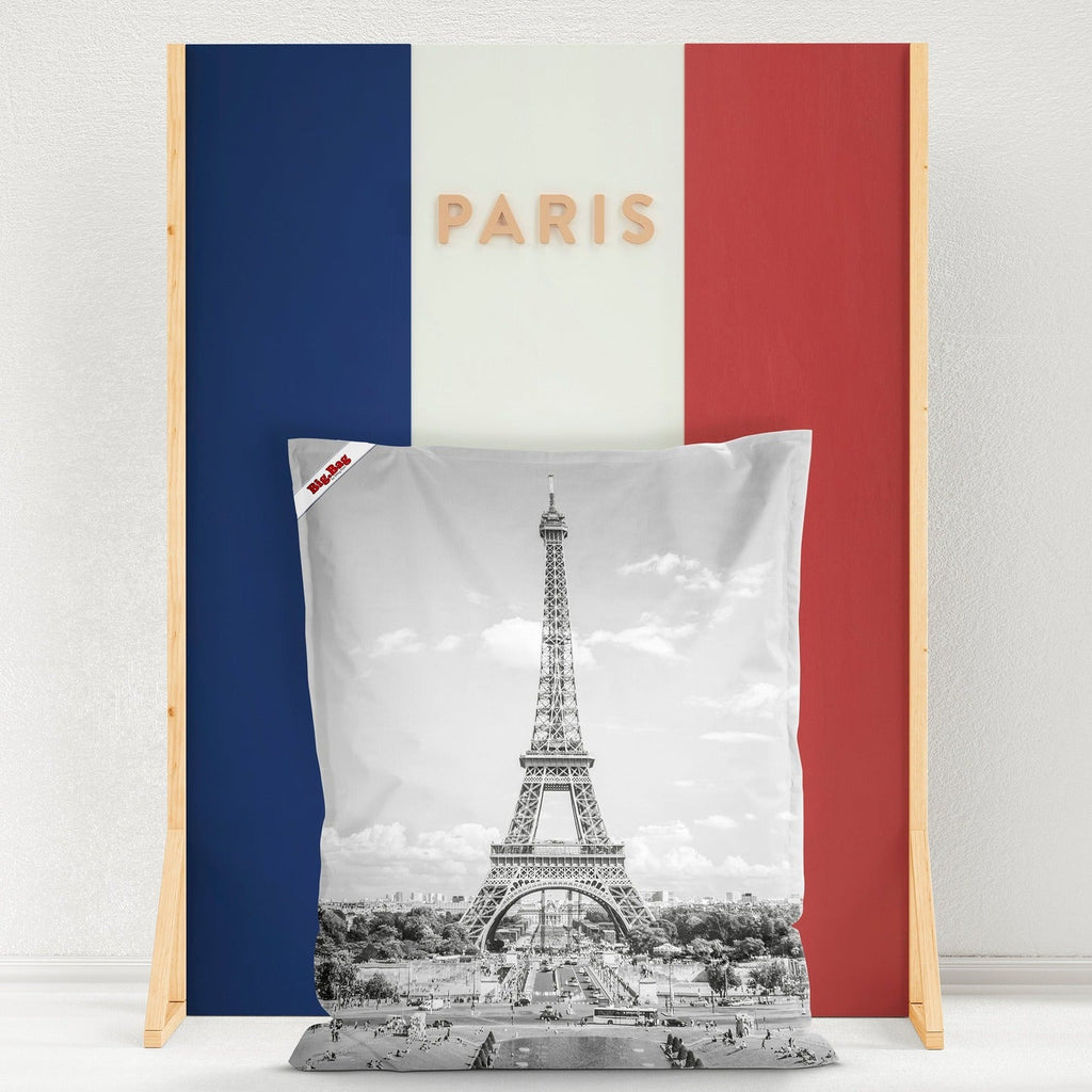 Decorative pillow with Eiffel Tower design on a stand with Paris text and French flag colors.