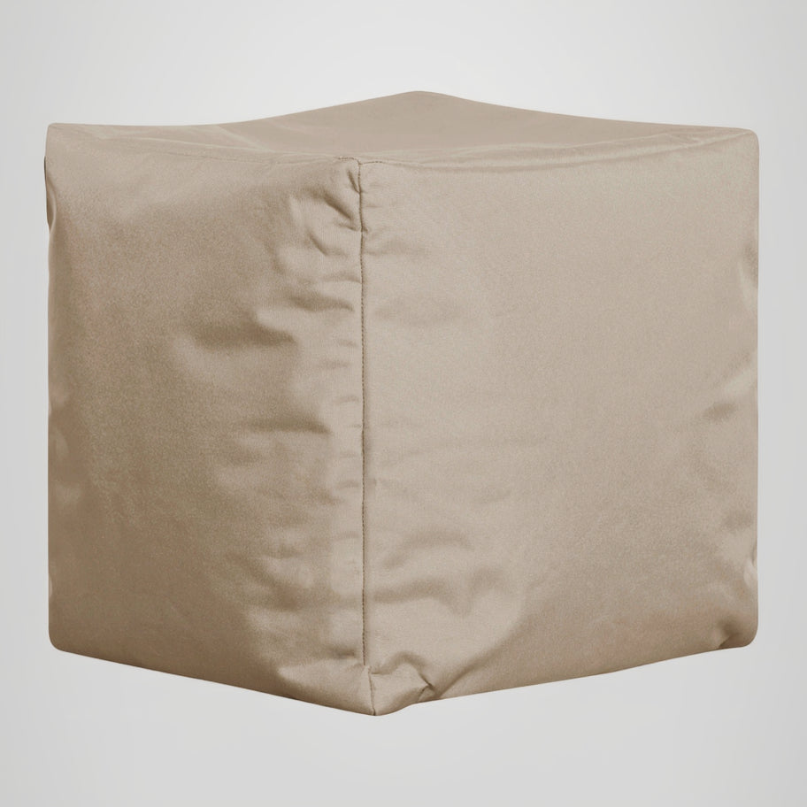 Beige cube-shaped ottoman on a light gray background
