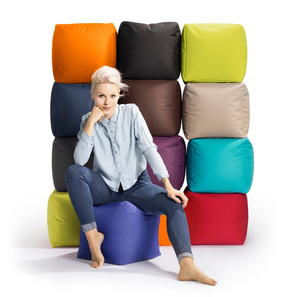 Woman sitting on a colorful bean bag chair with a white background