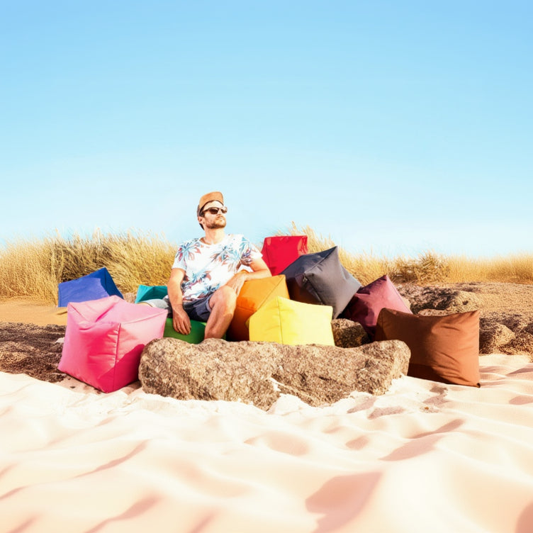Person sitting on a colorful bean bag chair in a desert setting