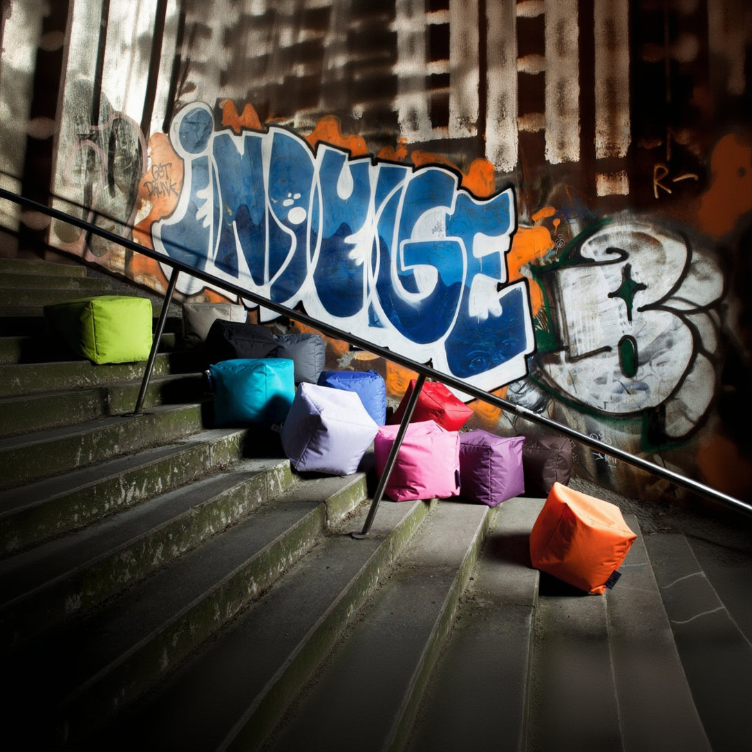 Colorful bean bags on a graffiti-covered staircase