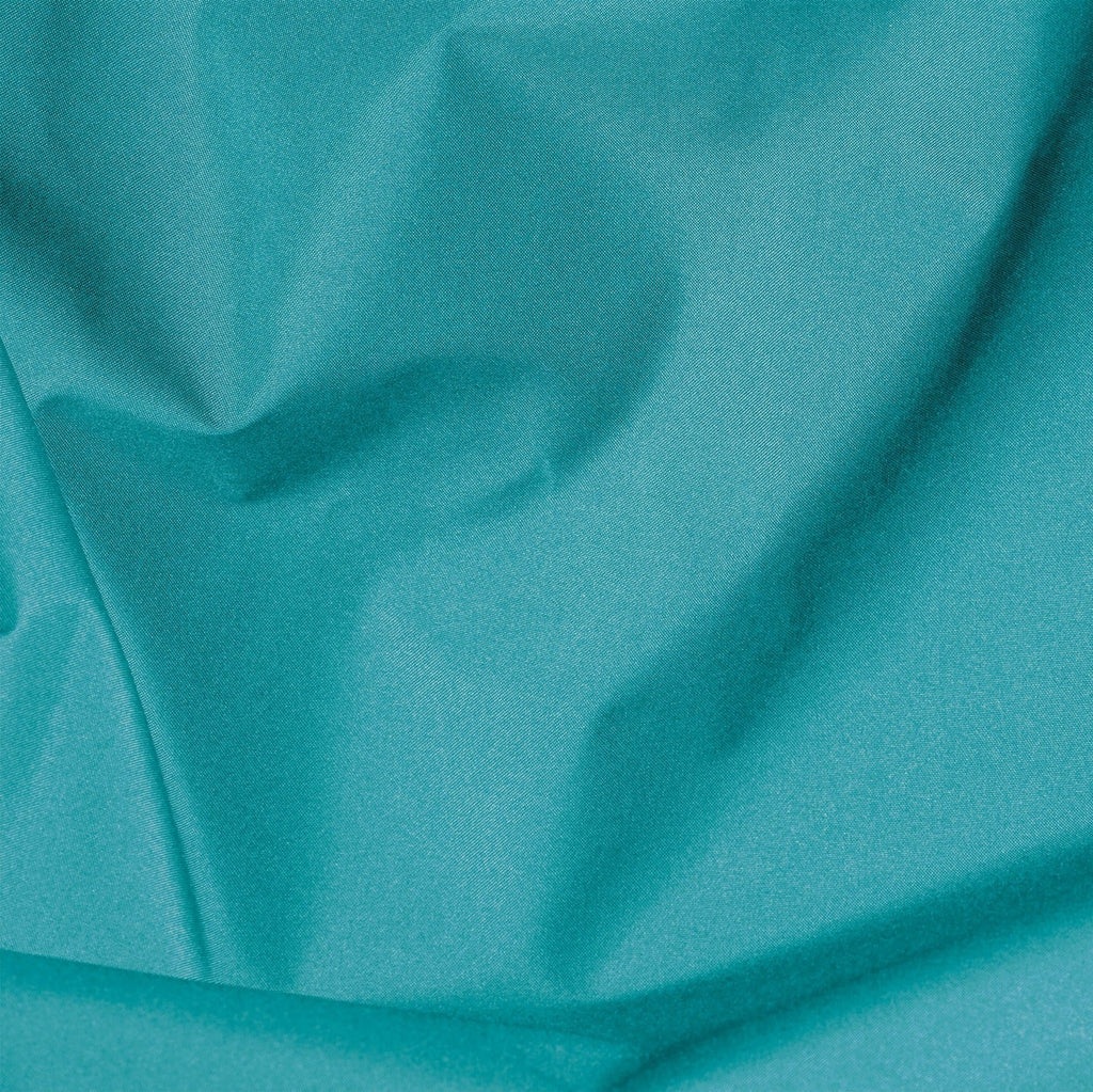 Close-up of teal fabric with folds