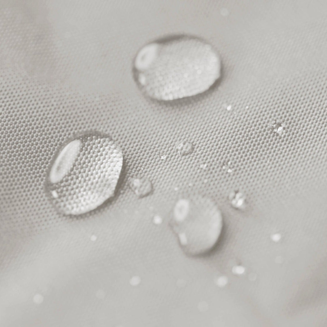 Water droplets on a textured gray surface