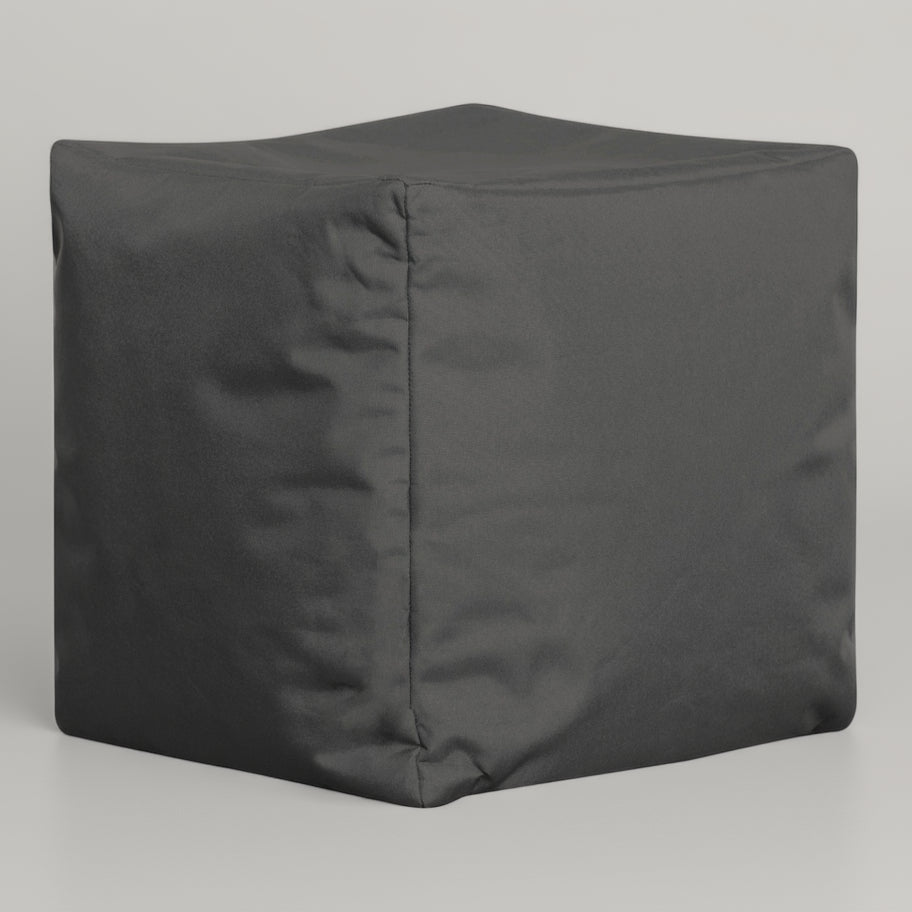 Gray cube-shaped ottoman on a light gray background