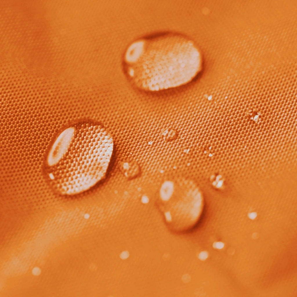 Water droplets on an orange textured surface