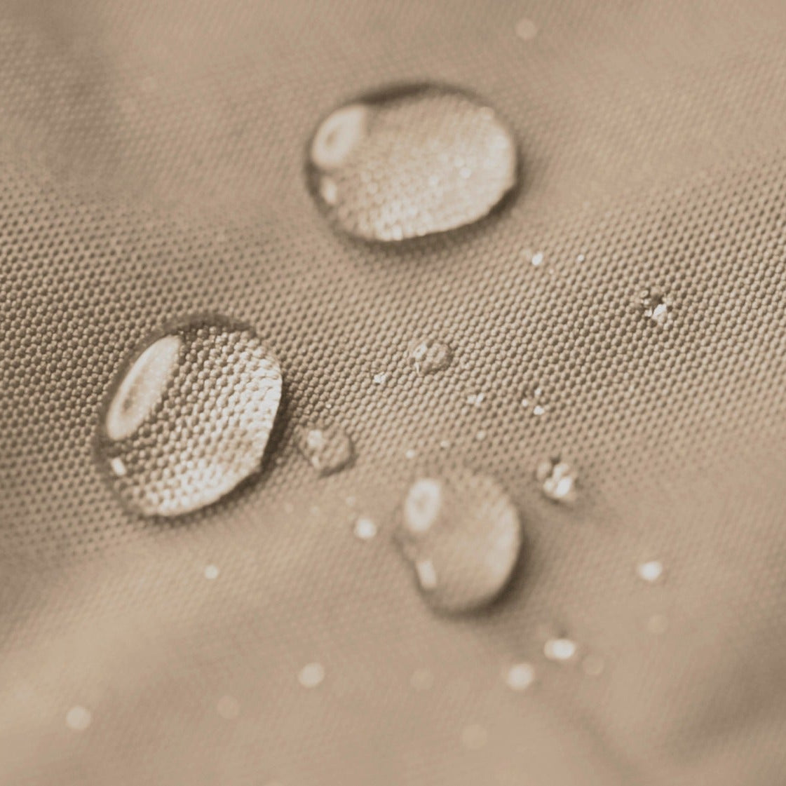 Water droplets on a textured beige surface
