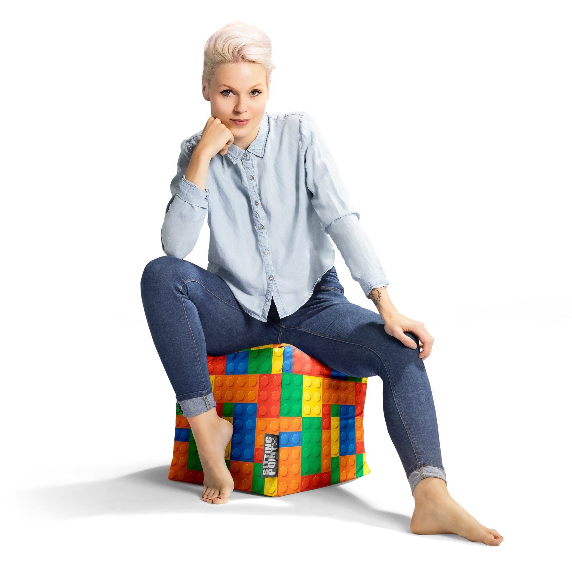 Person sitting on a colorful bean bag chair against a white background