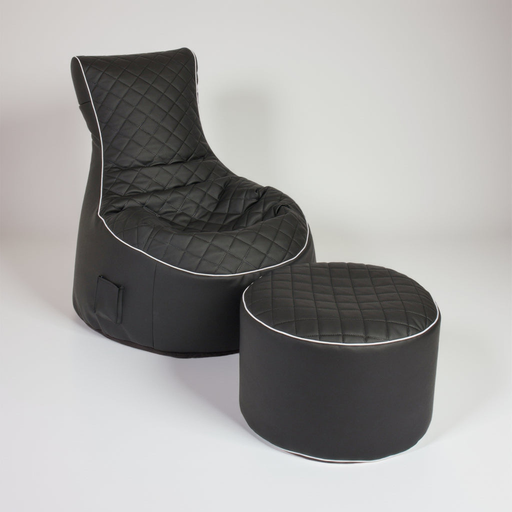Black quilted chair and ottoman set on a white background