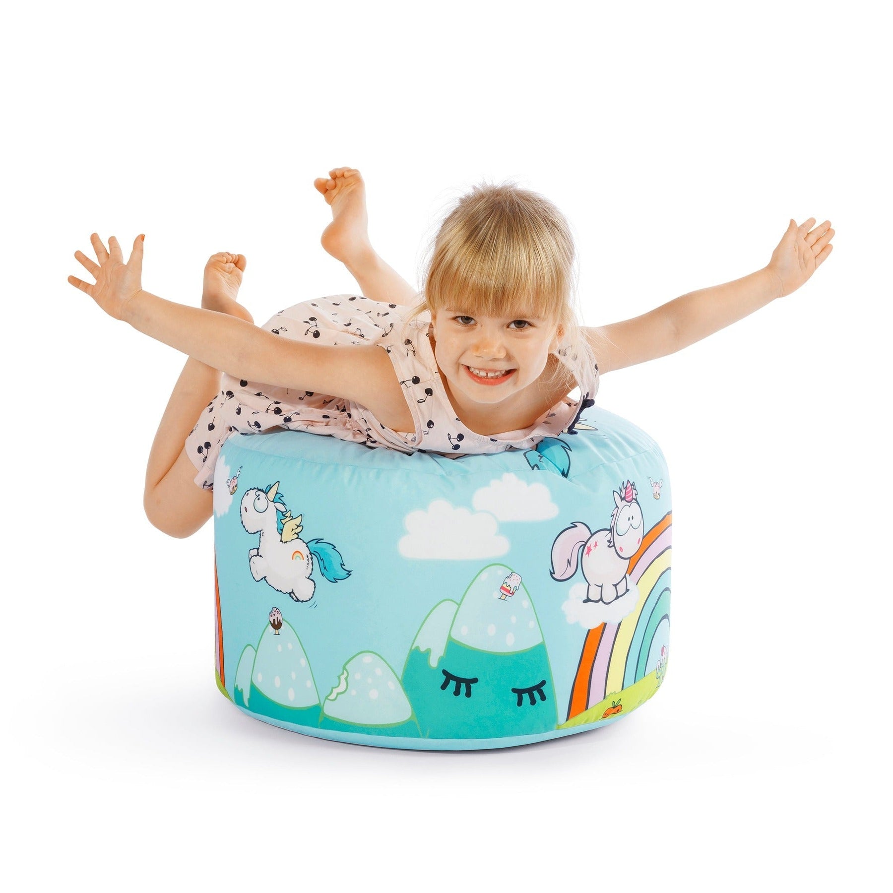 Child playing on a colorful bean bag with cartoon designs on a white background