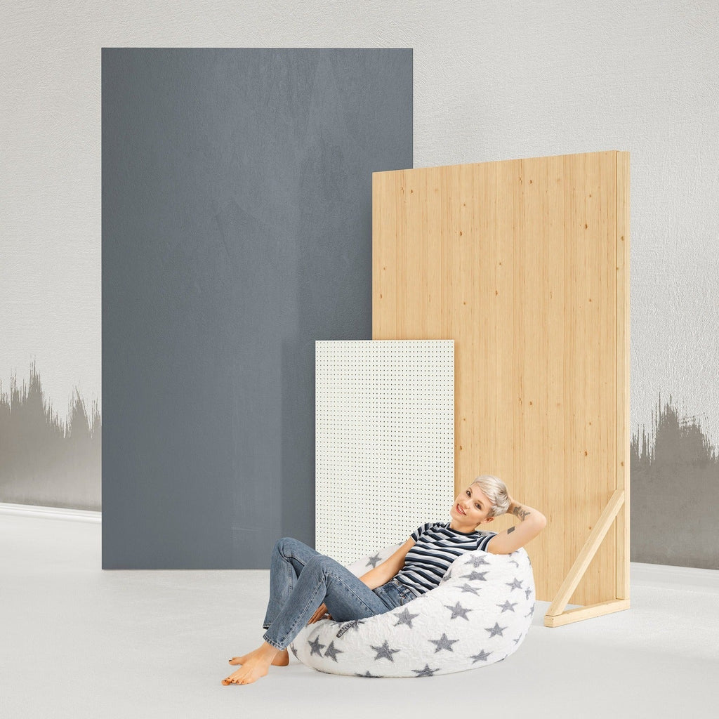 Person sitting on a bean bag chair next to acoustic panels in a minimalistic setting