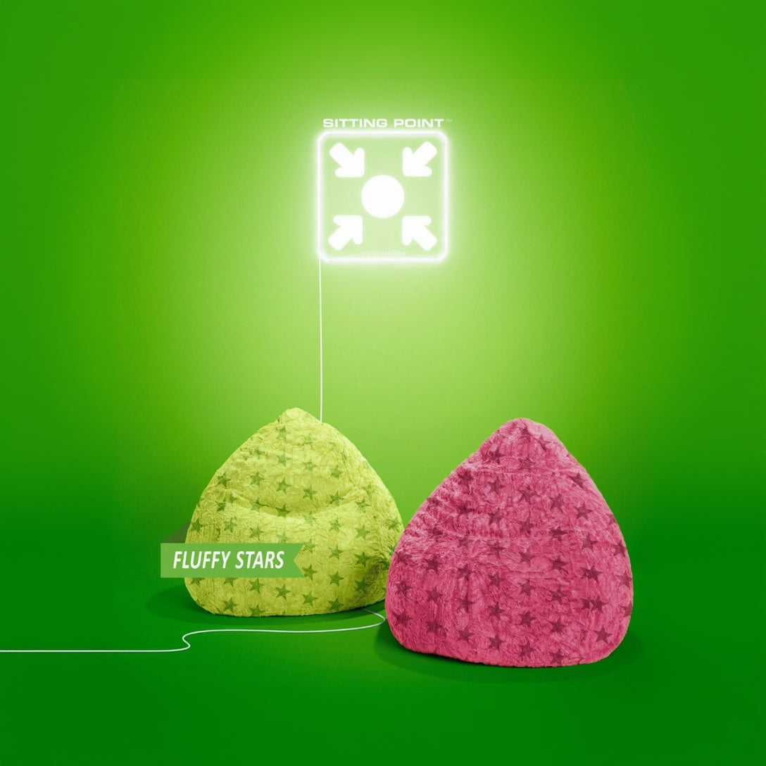 Two bean bags, one green with star pattern and one pink with star pattern, on a green background.
