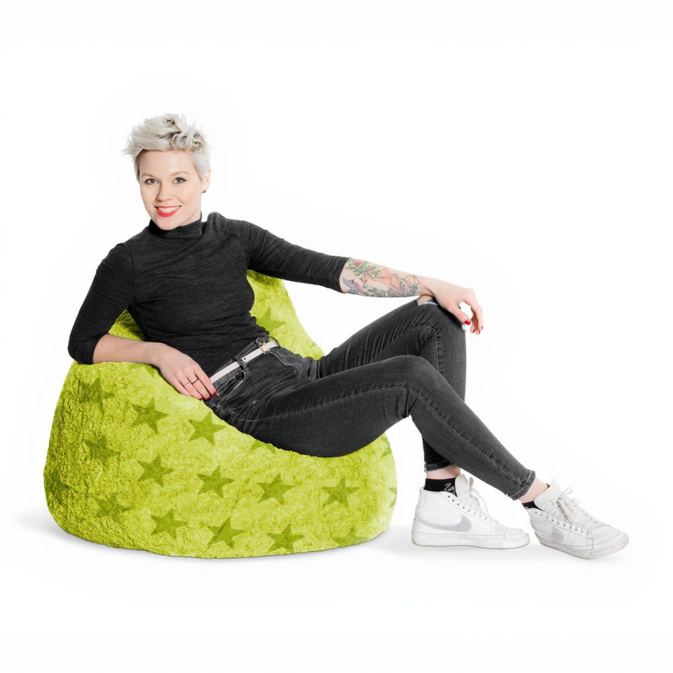 Person sitting on a green bean bag chair with a white background
