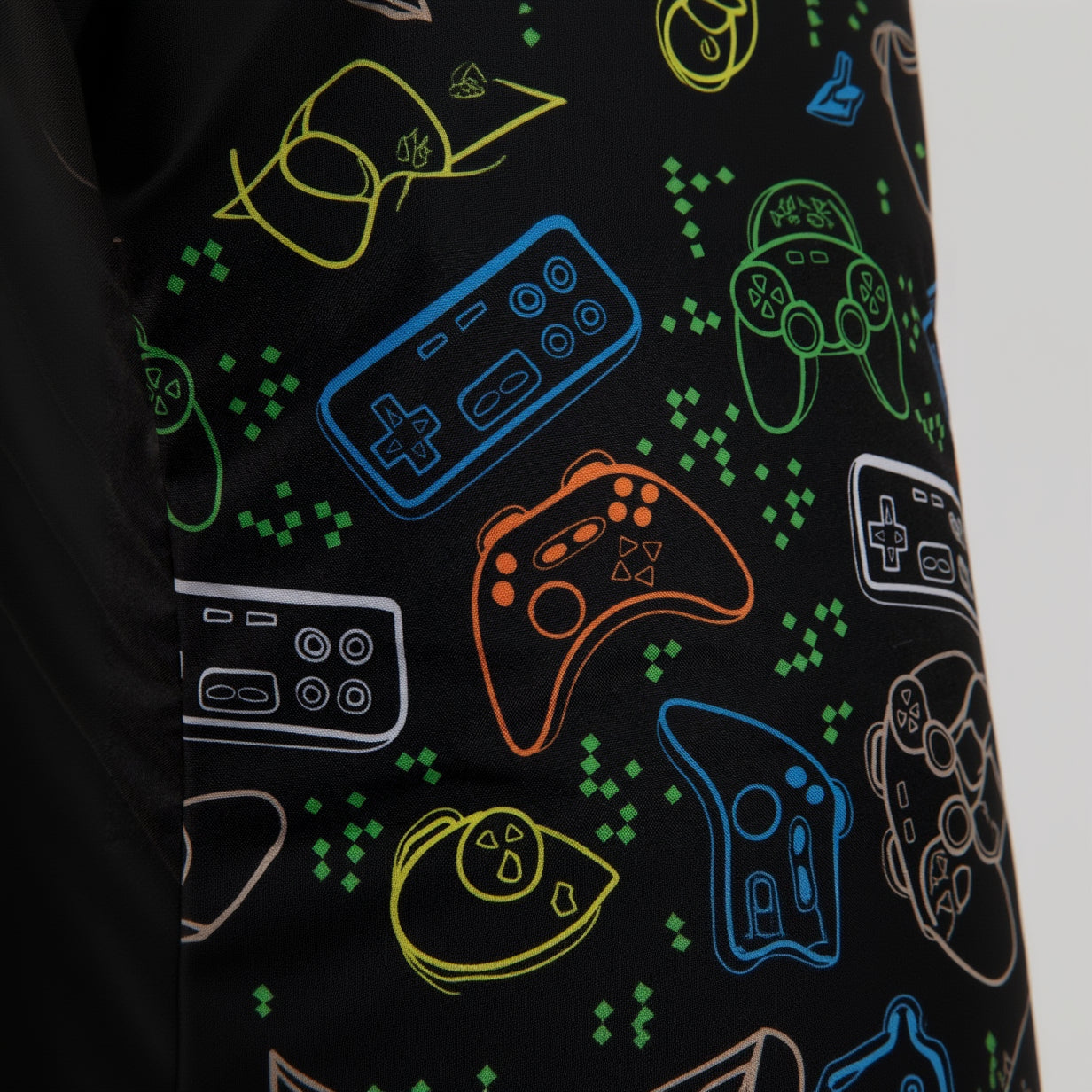 Fabric with colorful gaming controller patterns on a black background