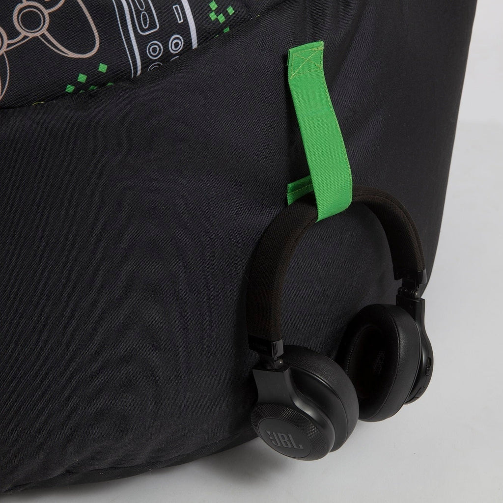 Black suitcase with green handle on a light gray background