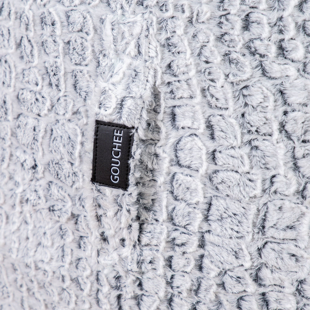 Close-up of a textured fabric with a 'Gouchée' label.