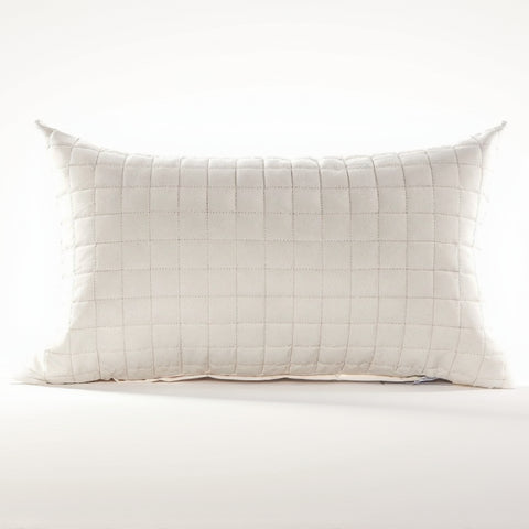 Quilted pillow with a grid pattern on a white background