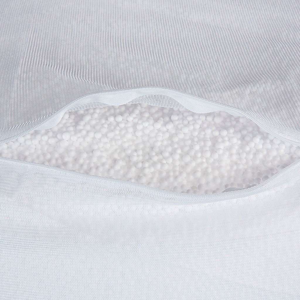 Close-up of a white pillow with visible stitching and fluffy interior.