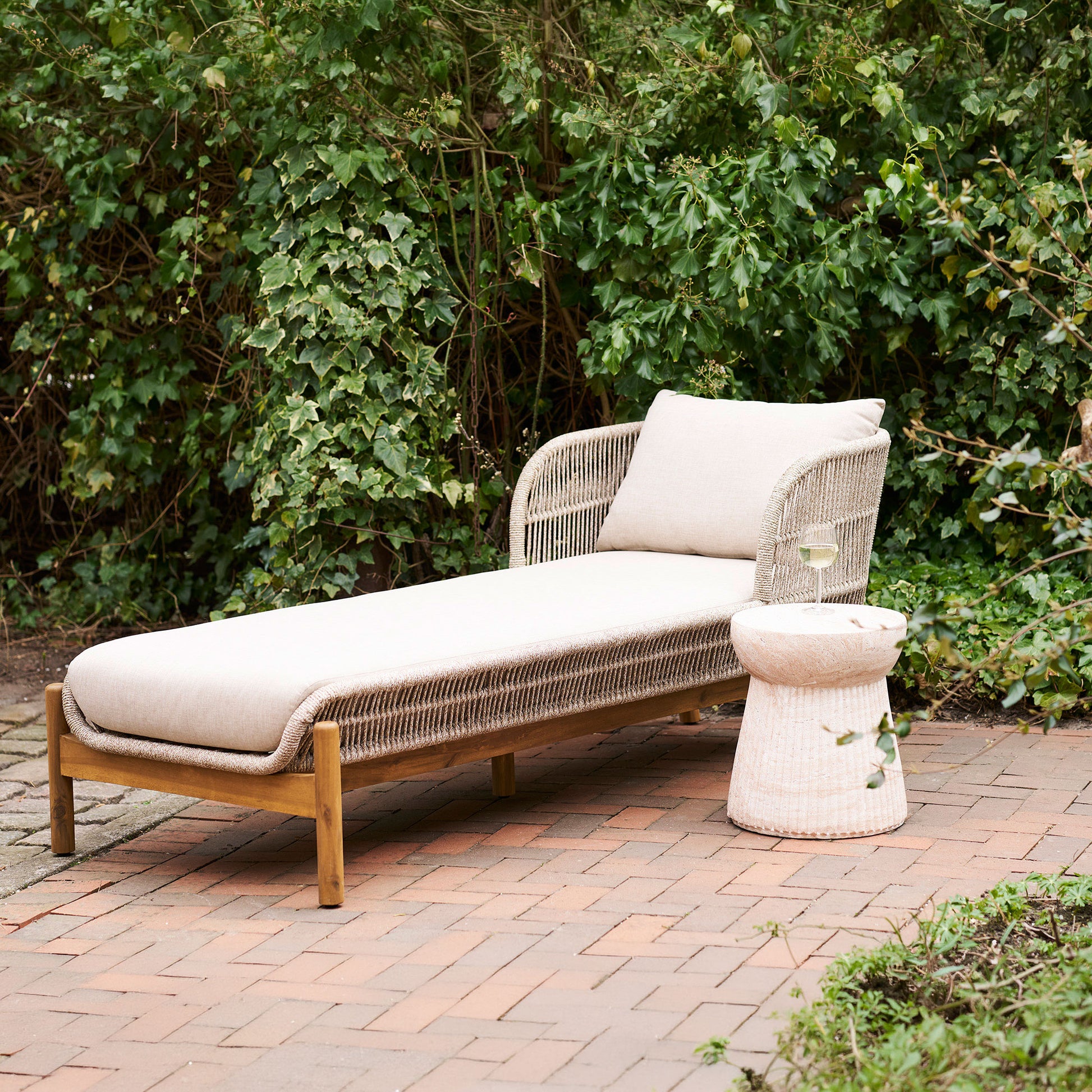 Portofino outdoor sun lounger styled on patio with greenery