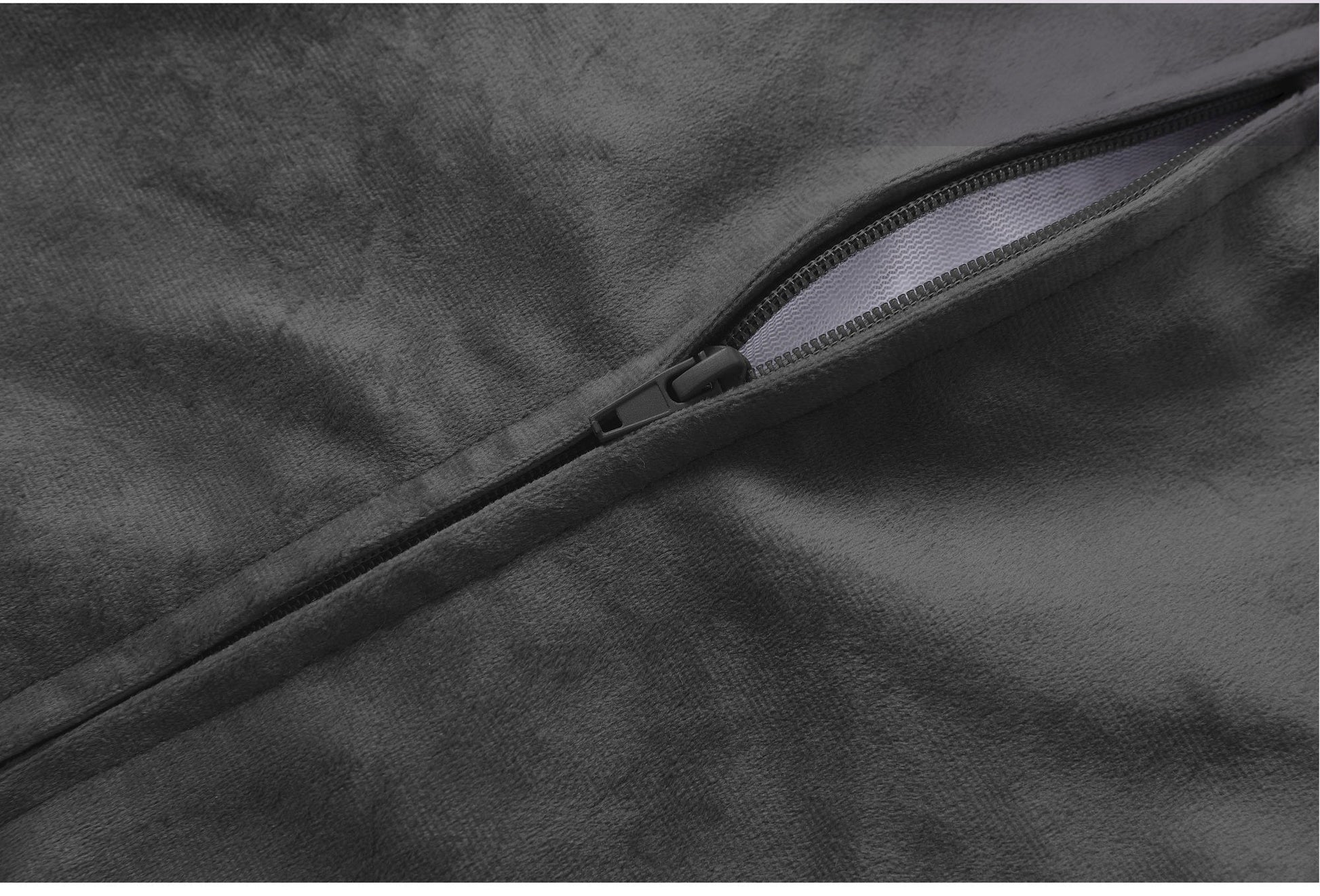 Close-up of a zipper on a dark fabric surface