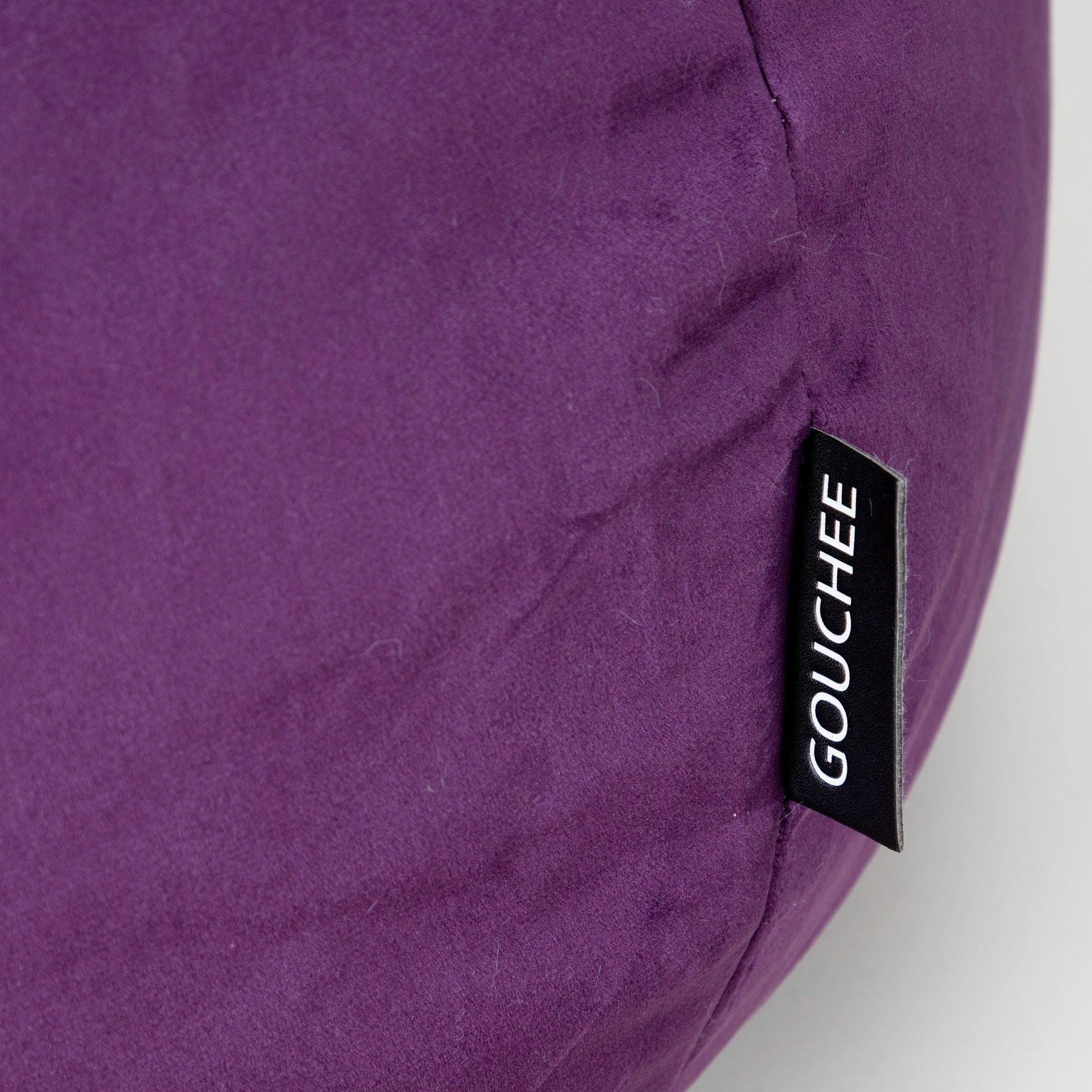 Purple bean bag with 'Gouchee' label on a white background