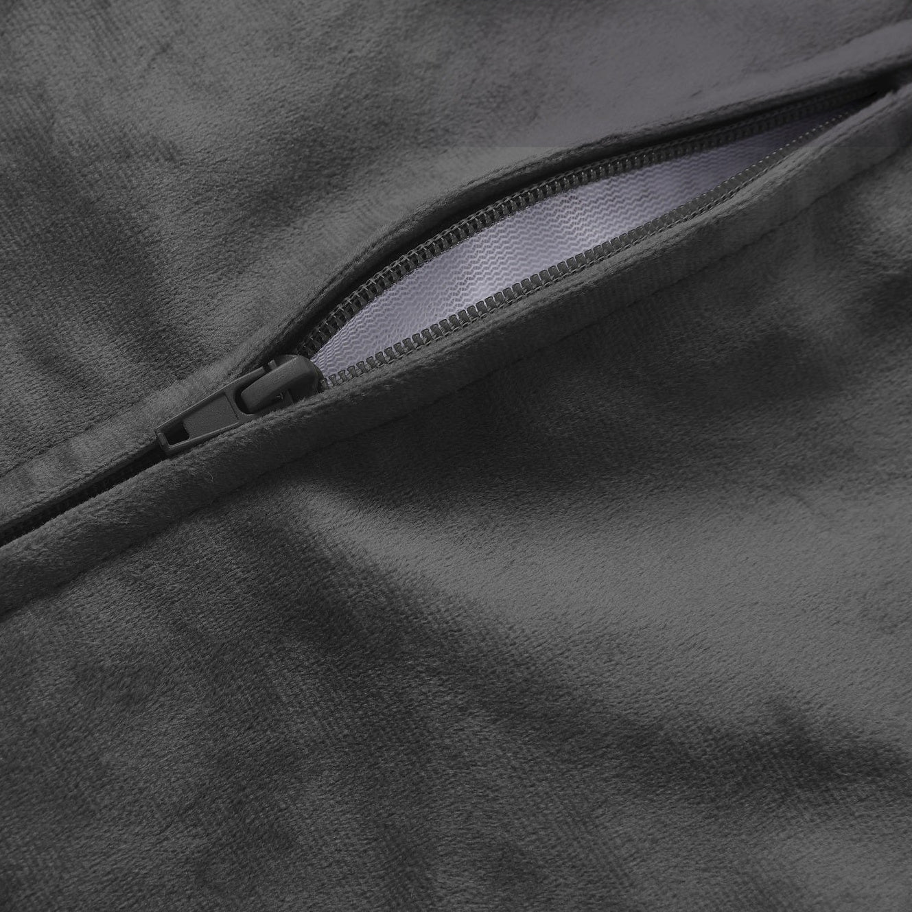 Close-up of a zipper on a dark fabric surface