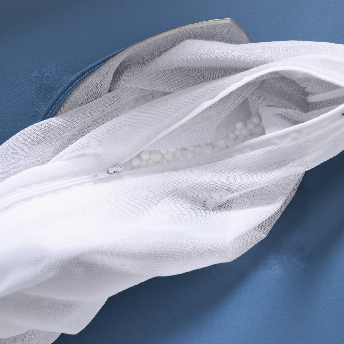 White mesh laundry bag with blue fabric in the background
