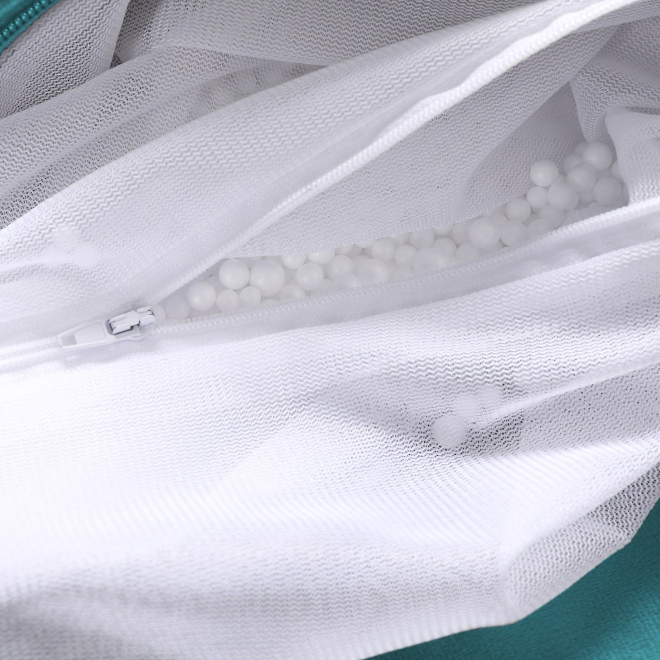 White mesh bag with a zipper on a green background