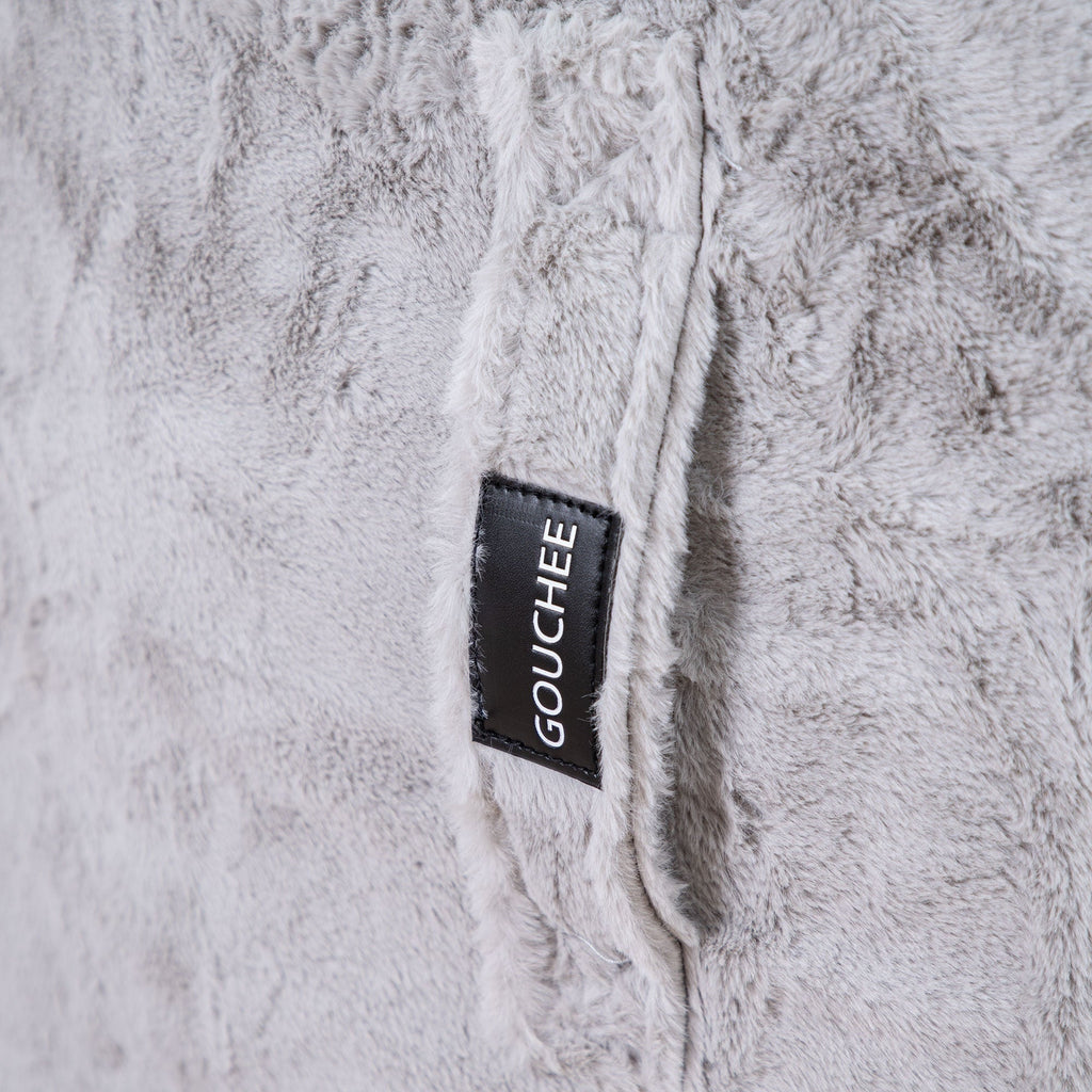 Close-up of a textured fabric with a 'Gouchee' label.