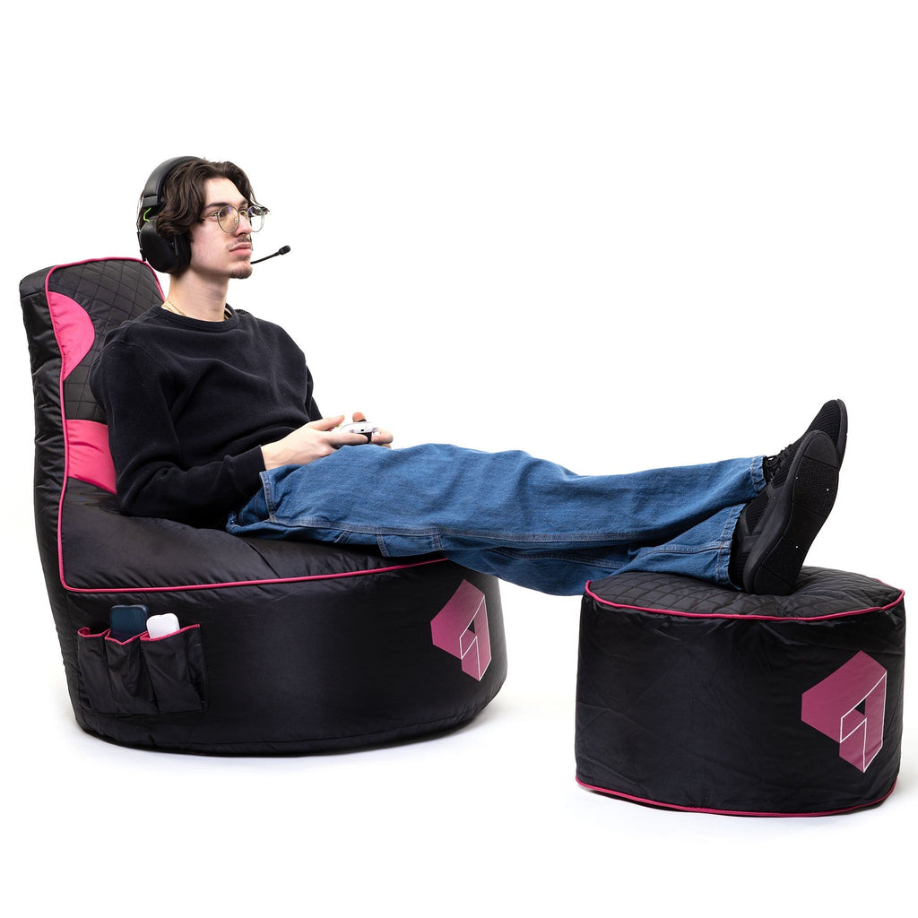 Person sitting in a black and pink gaming chair with a white background