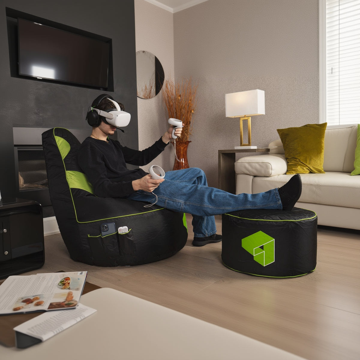 Person using VR headset and controllers in a living room with a bean bag chair and ottoman.