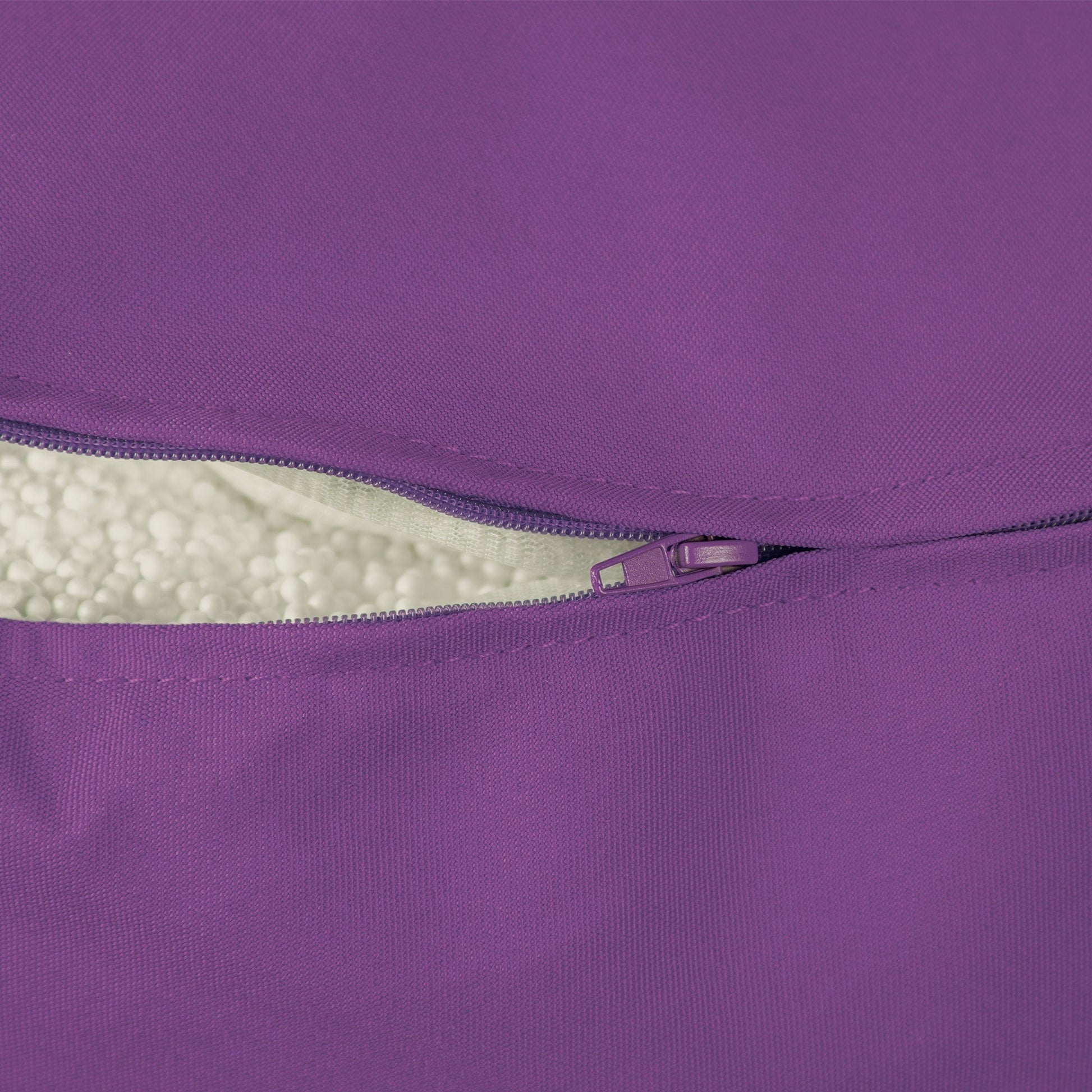 Close-up of a purple zipper on a product, with white interior visible.