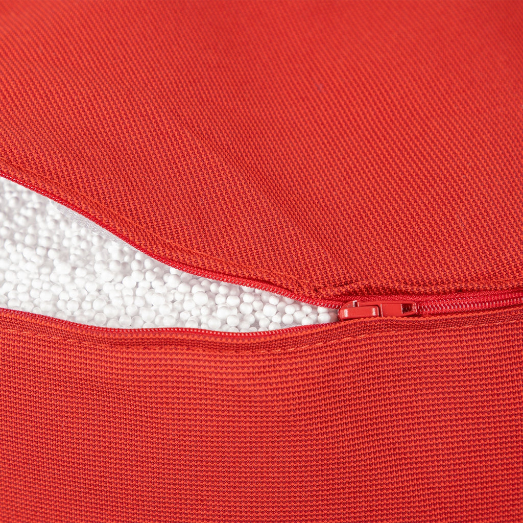 Close-up of a red fabric with a zipper, showing texture and color.