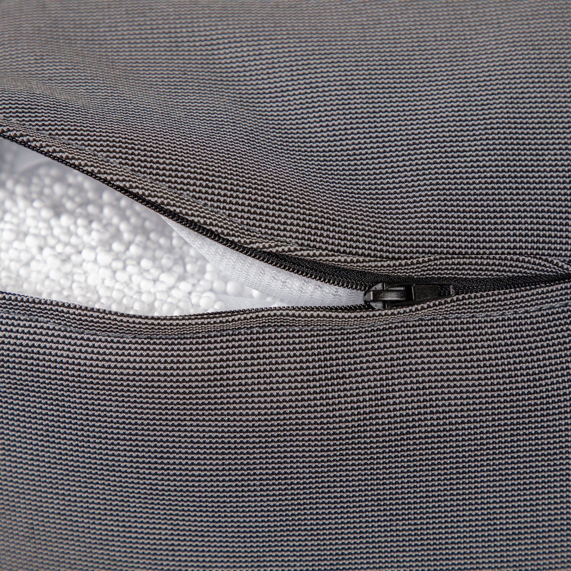 Close-up of a textured gray bag with a zipper, showing the interior lining.