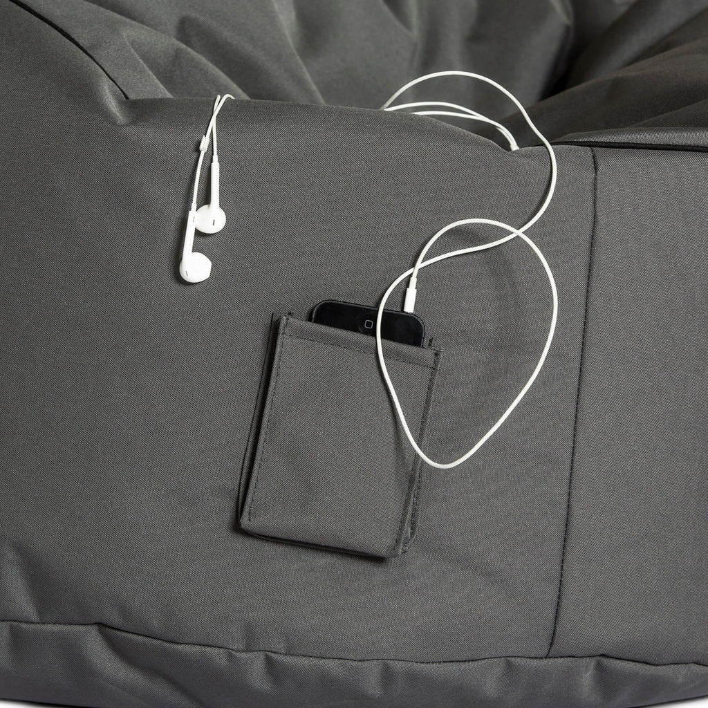 Gray bean bag with a pocket and earphones on a white background